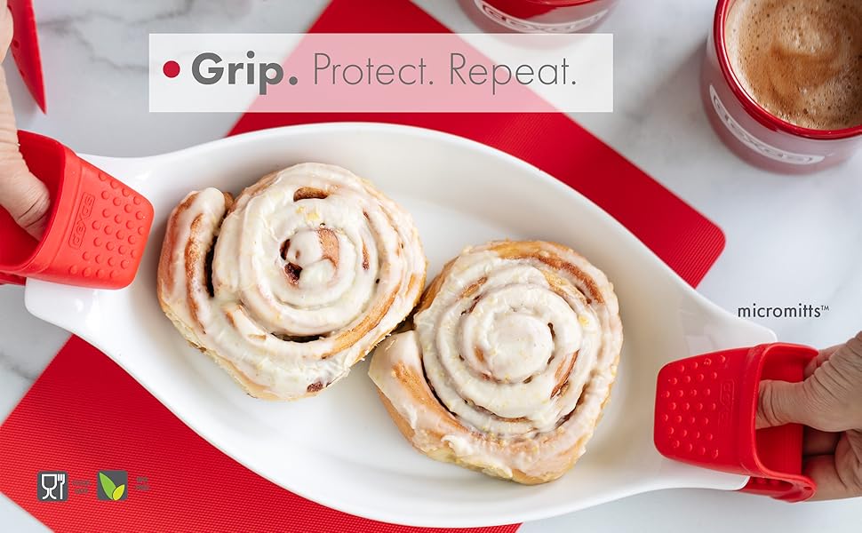 silicone mitts holding cinnamon rolls in white plate