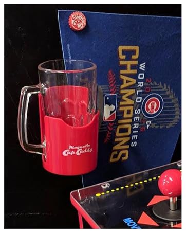 Image of magnetic drink caddy holding a tumbler mug next to arcade machine.