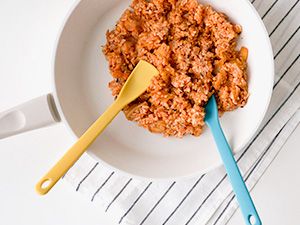 Mini silicone cooking spoon for stir-frying in a nonstick frying pan