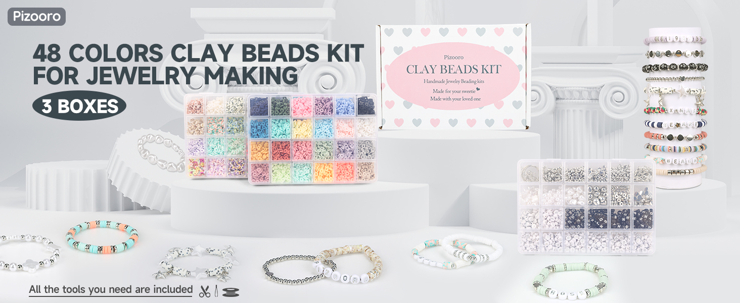 clay beads set in white sculptural buildings, some beautifully crafted jewellery.
