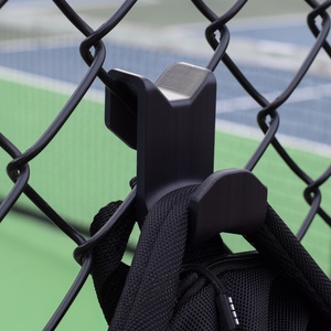 Fence Buddy hook installed on chain link fence holding a bag strap