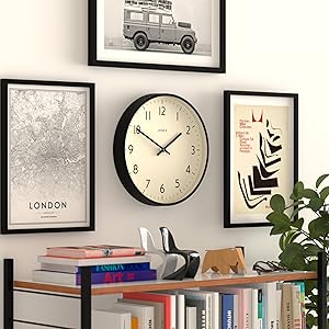a wall with a clock on it and a bookshelf.