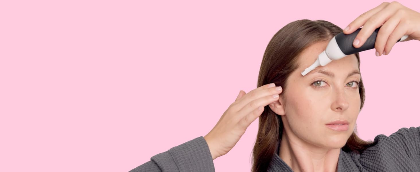 Woman using face trimmer