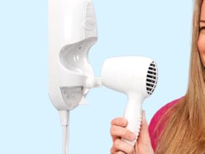 Woman with wall mounted hair dryer