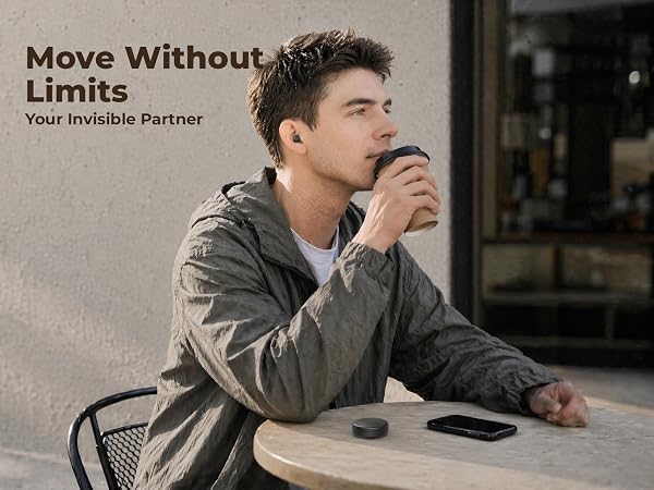 Man wearing a mini invisible wireless earbud while having coffee, nearly unnoticeable