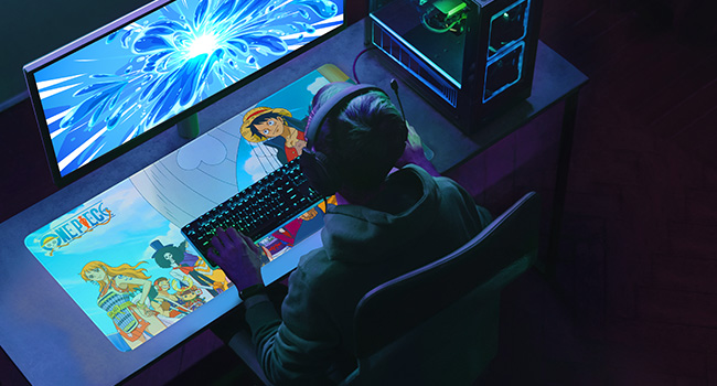 Gaming setup with bright blue lighting, showing multiple monitors or screens in a dark environment. RGB lighting effects visible.