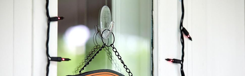 Command Window Hook on outdoor window on a house holding a sign