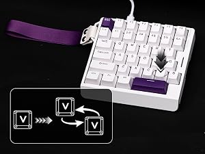 Compact white mechanical keyboard with purple accents and strap. Black diagram in corner showing 'V' key directional movement indicators.