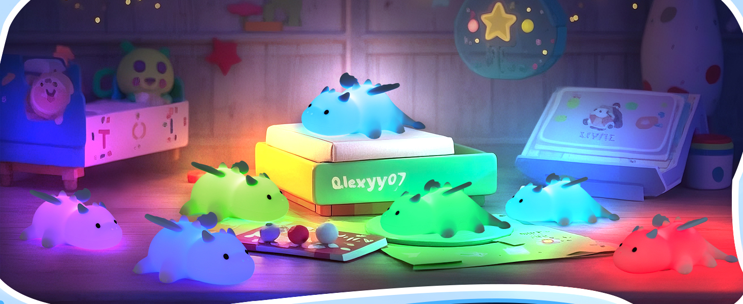 Colorful silicone night lights shaped like cute dinosaurs. Various sizes emit soft glows in blue, green, pink, and yellow. Displayed on boxes in a dimly lit room setting.