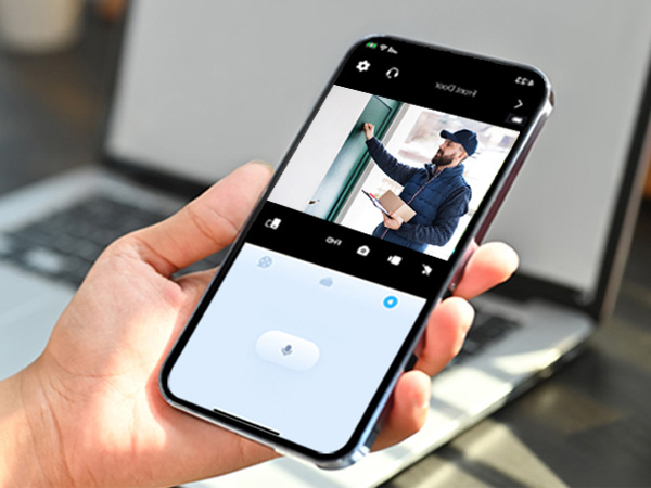 a hand holding a smartphone with a photo of a man on the screen.