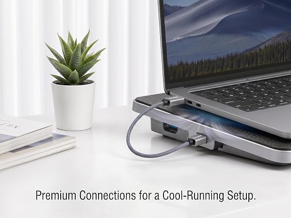 USB-A cable powering a laptop cooling pad in a clean desk setup.