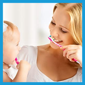 Woman and small child brushing teeth