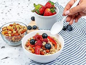 Spoon about to dip in a bowl of oatmeal.