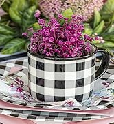 Black and white plaid mug sits on a matching paper plate and holds a purple faux plant