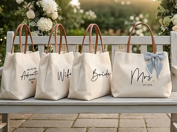 Four high quality personalized wedding canvas totes displayed on a garden bench as luxury gifts.