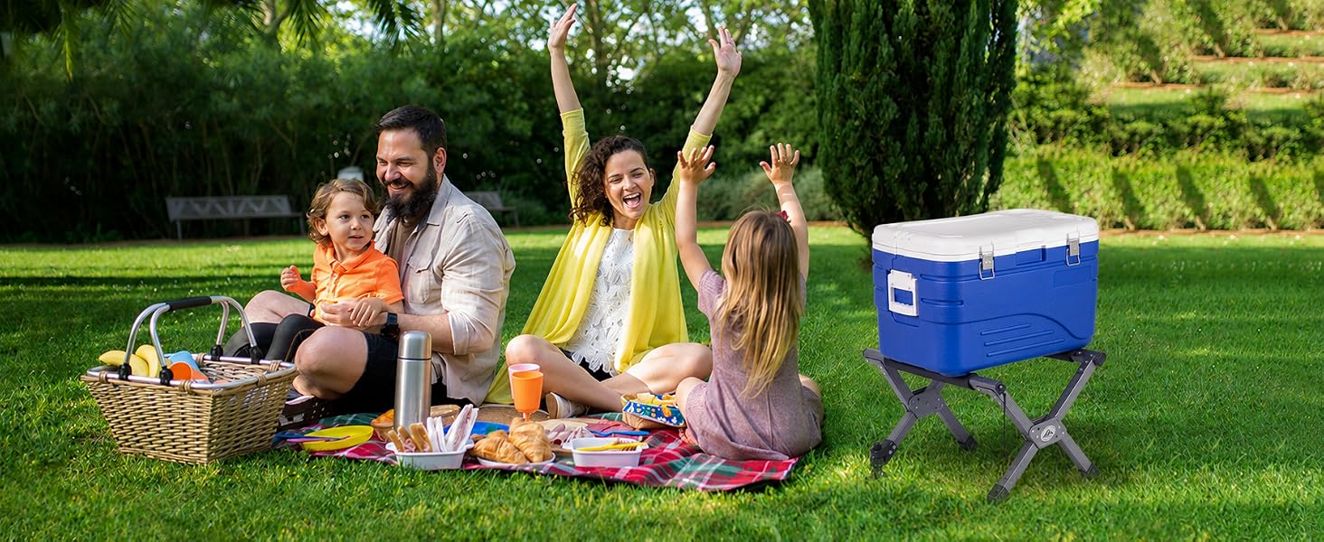 Family picnic with an Ablazer folding cooler stand holding a blue cooler on grass