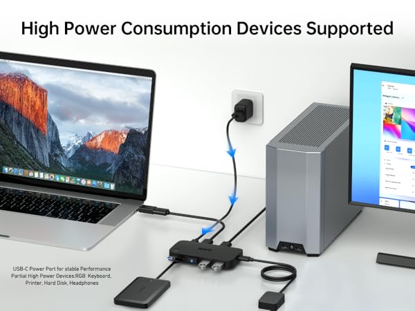 USB hub setup supporting high-power devices. Shows laptop, external drive, and monitor connected to a multi-port USB hub with blue cables.
