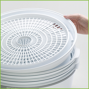 Drying trays nest when not in use, saving storage space.