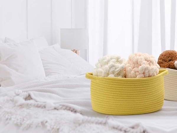 several storage baskets on the tidy bed, which are filled with wool balls and doll toys