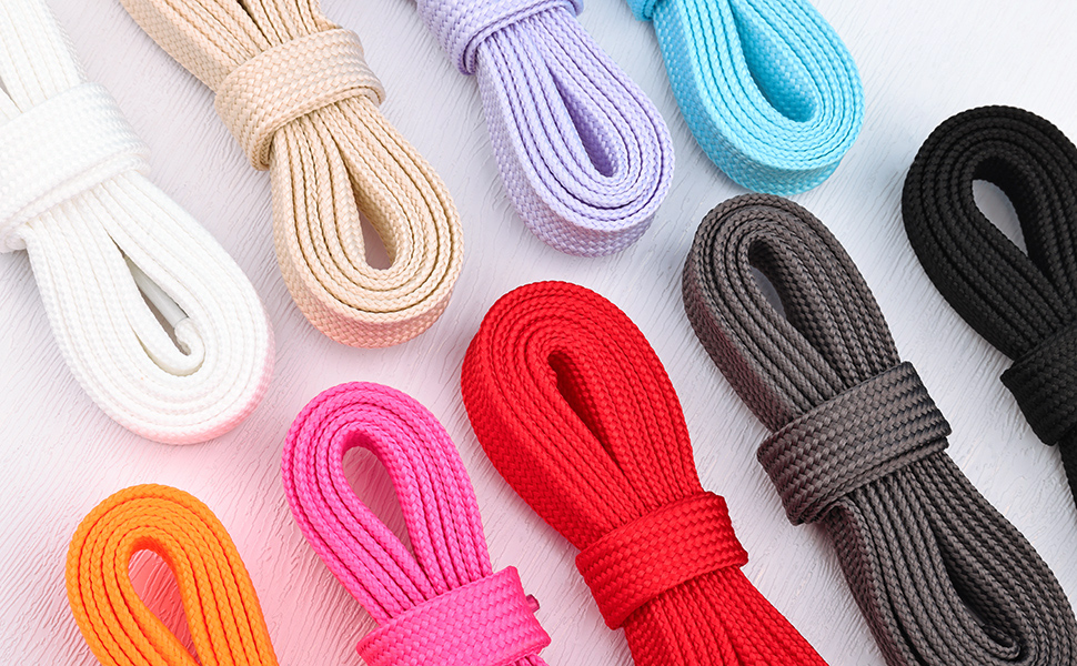 Assortment of colorful shoelaces in white, purple, light blue, black, red, pink, and orange, neatly coiled and displayed.