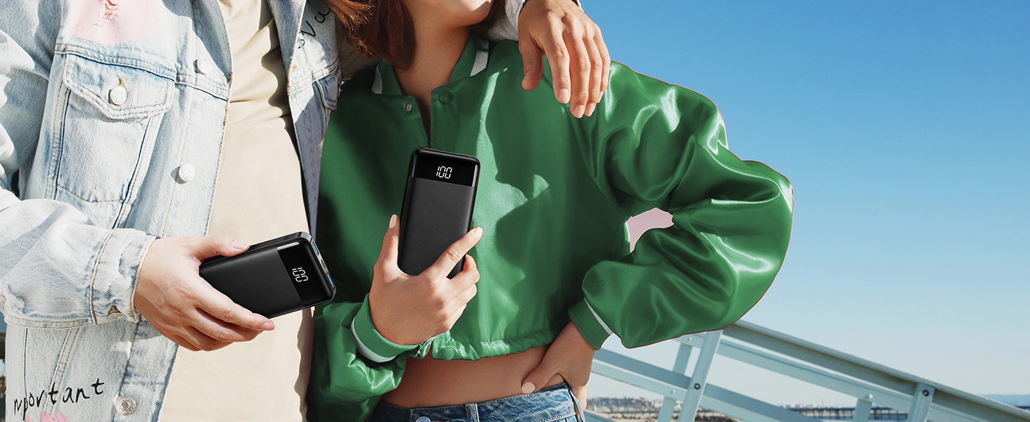 Two people holding black rectangular devices