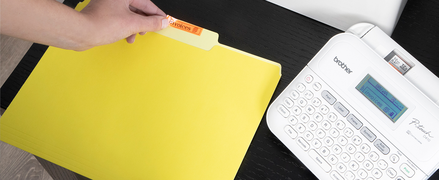 Person applying "Invoices" label to manila file folder
