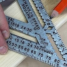 Carpenter using Swanson S0100 Speed Square Pro scribe notches to mark a precise line on a wood board