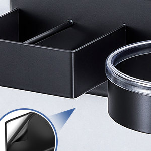 Close-up of black rectangular container with two compartments. Clear circular lid visible. Appears to be a storage or organizational product.