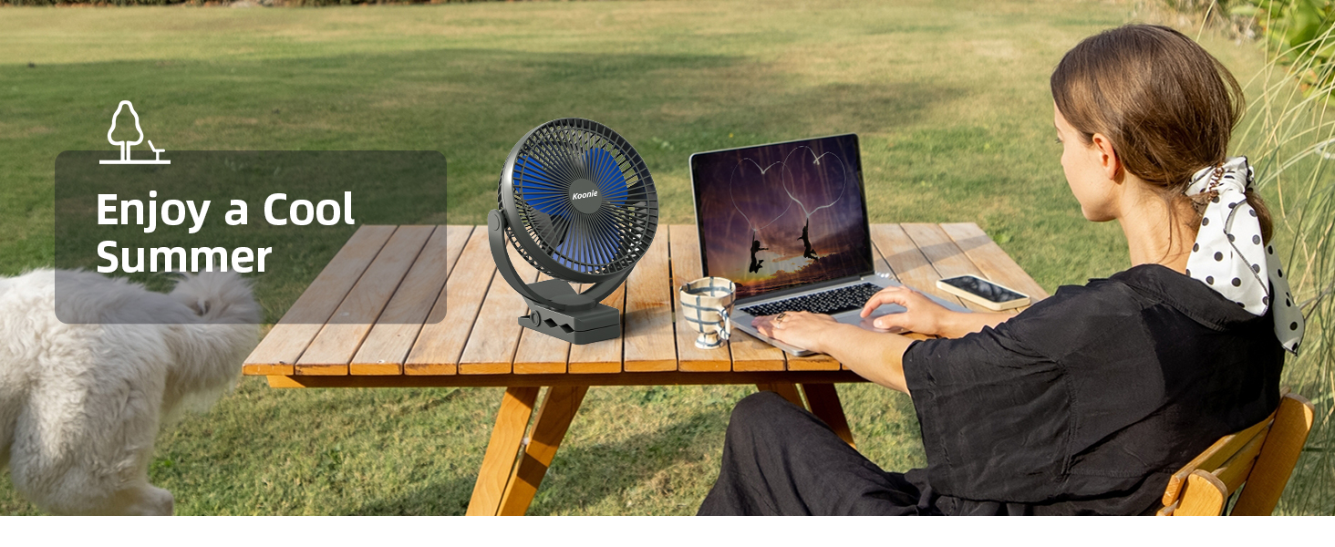 Outdoor scene with person using laptop on wooden table. Small electric fan nearby. Text overlay says 'Enjoy a Cool Summer'.