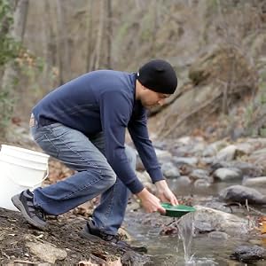 image of man with gold pan by stream