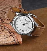 Analog wristwatch with white dial, brown leather strap, and date display, placed on a leather surface with map details visible.