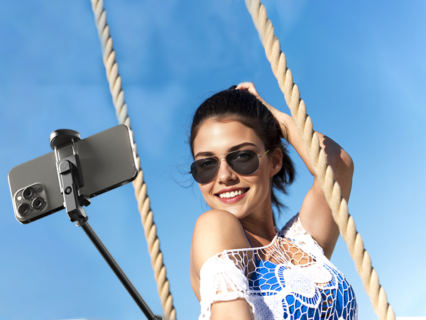 Series of images showing selfie stick in use against blue sky background, demonstrating extension and positioning capabilities.