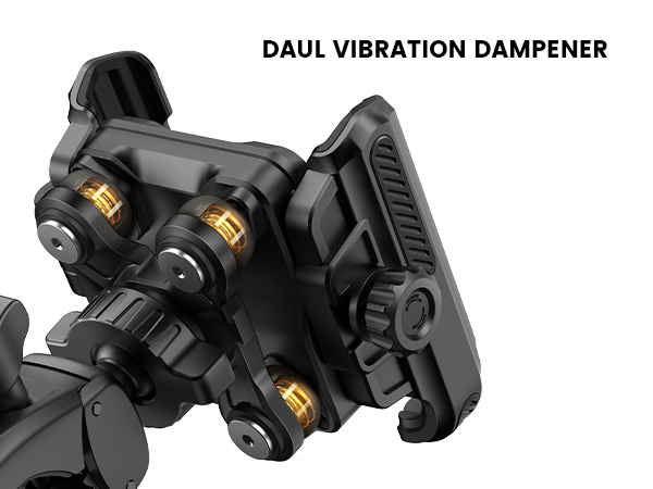 Text reads 'DAUL VIBRATION DAMPENER'. Close-up of black mechanical device with gold-colored adjustment knobs and textured grip surface.