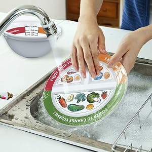 The plates and bowls being washed in the sink.
