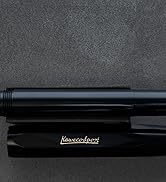 Series of views showing a black metal pen with sleek design. Text reads 'Klous+Urbans'. Multiple angles display the pen's barrel, clip, and tip details.
