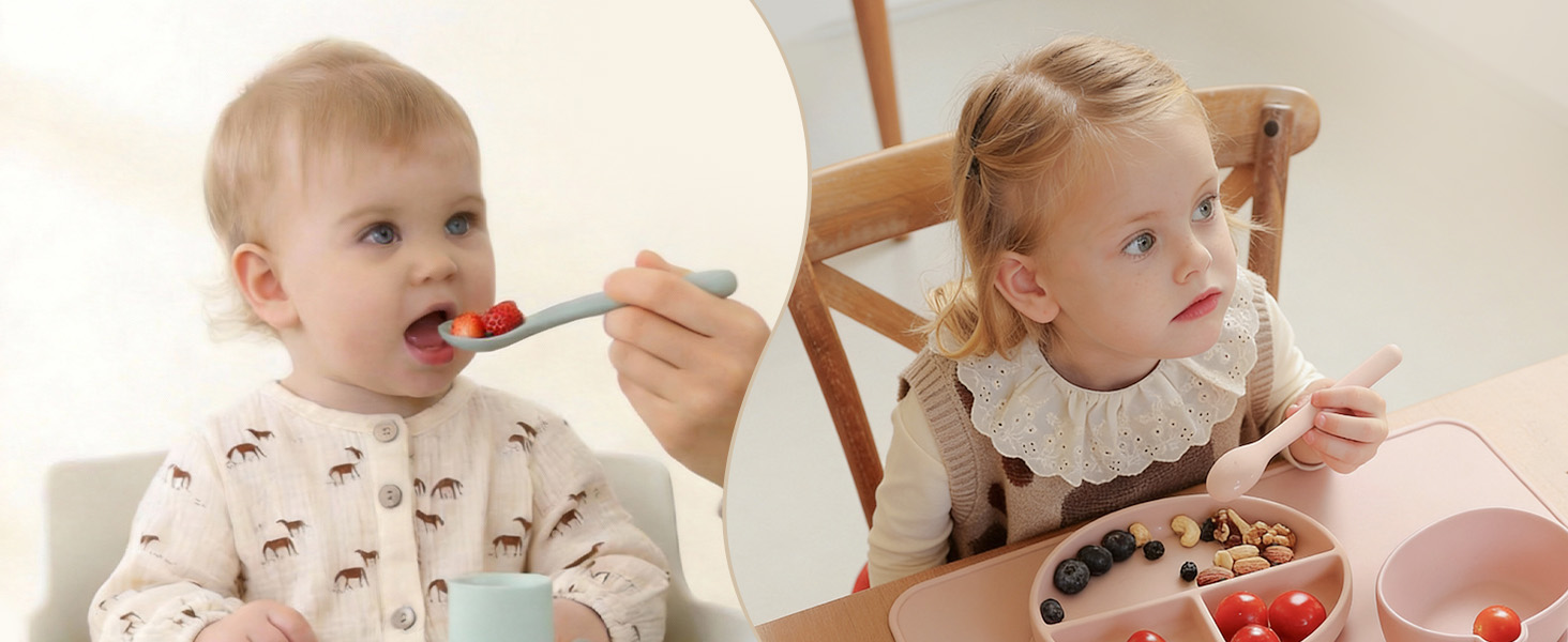 Two young children sitting at a table eating food, wearing light-colored clothing with patterns.