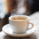 Steaming cup of delicious coffee