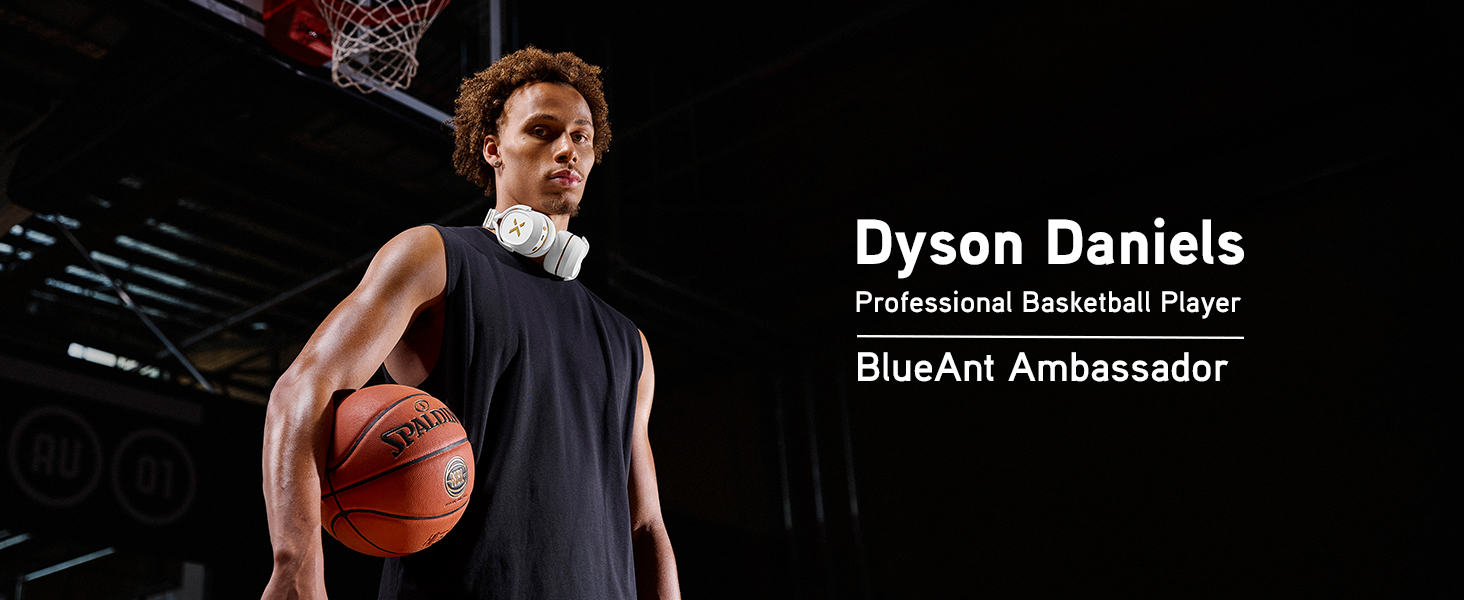 Dyson Daniels on an basketball court wearing white Pump X headphones around his neck