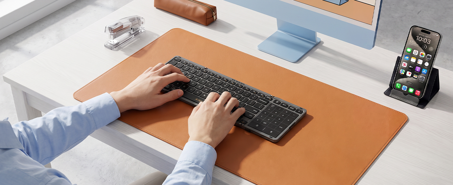 Aimarz AF01 keyboard used with a desktop monitor and phone in an everyday work setup.