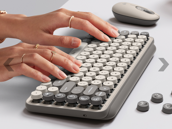 zoom of a woman typing on pop keys mist wireless mechanical beige gray keyboard