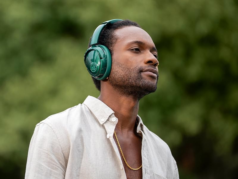 A man wearing lux headphones with be aware mode on outside