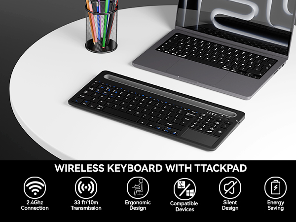 Wireless keyboard with trackpad and phone holder on desk next to laptop for home office use