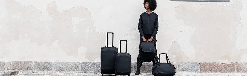 A person holding a Thule Subterra 2 laptop backpack