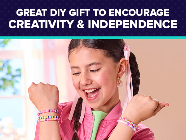 Girl posing with their finished bracelets on wrists