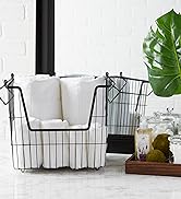 Metal storage bin in bathroom organizing towels