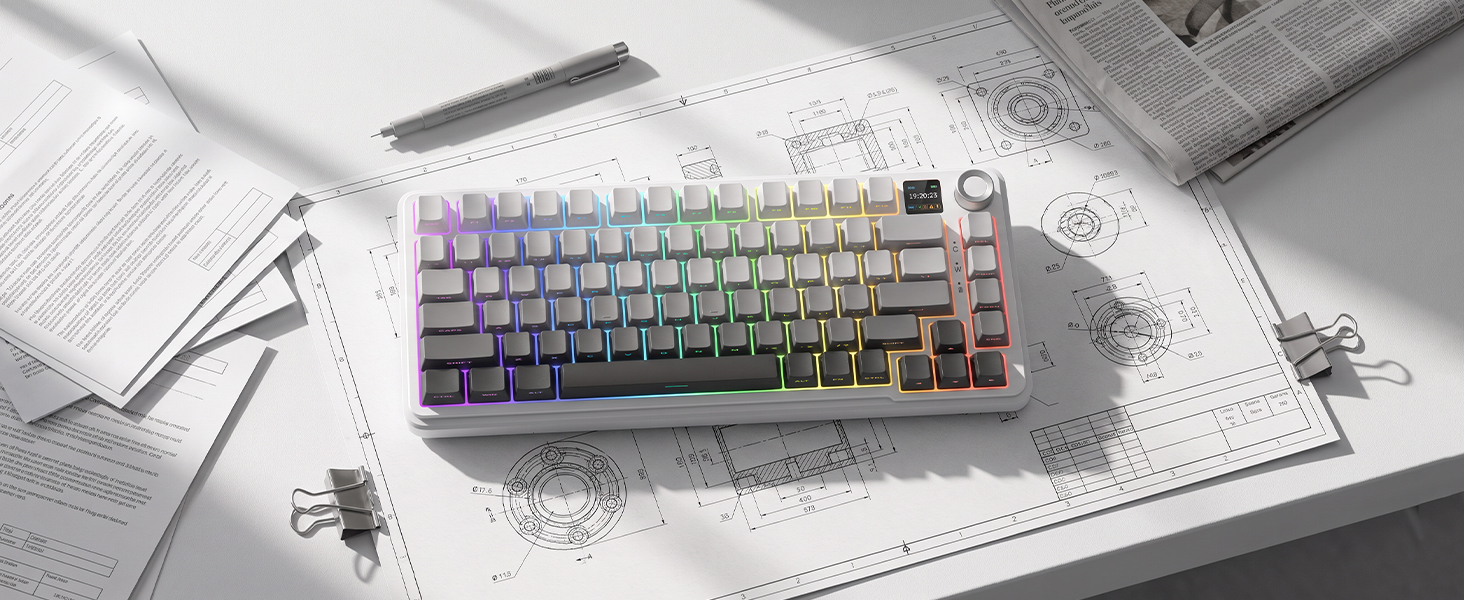 Purple and white mechanical keyboard with gradient keycaps positioned on white technical blueprint paper with sketches and drafting tools visible.