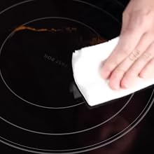 hand cleaning up the residual mess with a paper towel