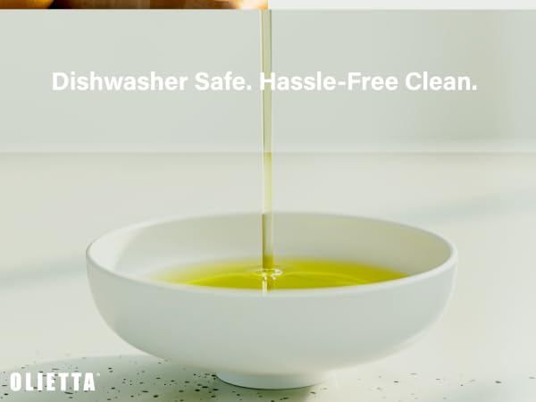 Yellow oil being poured into a white ceramic bowl, with text indicating the bowl is dishwasher safe and easy to clean.