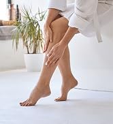 Woman rubbing lotion onto legs