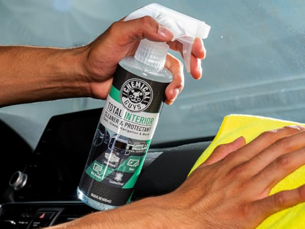 Cleaning car interior controls and buttons with Total Interior Cleaner spray